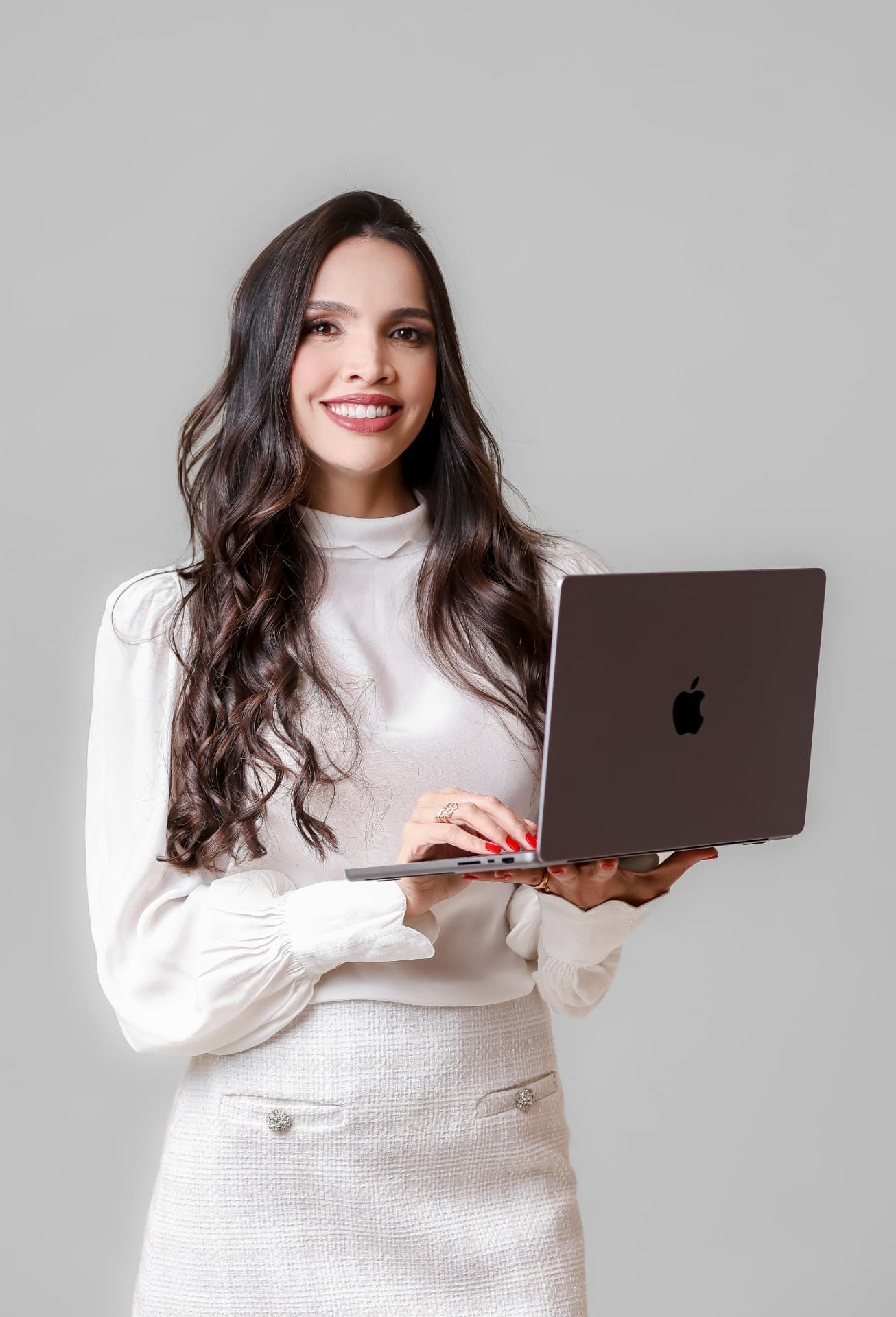 Bruna Fernandes, criadora do Precificação Lucrativa, segurando um notebook e sorrindo